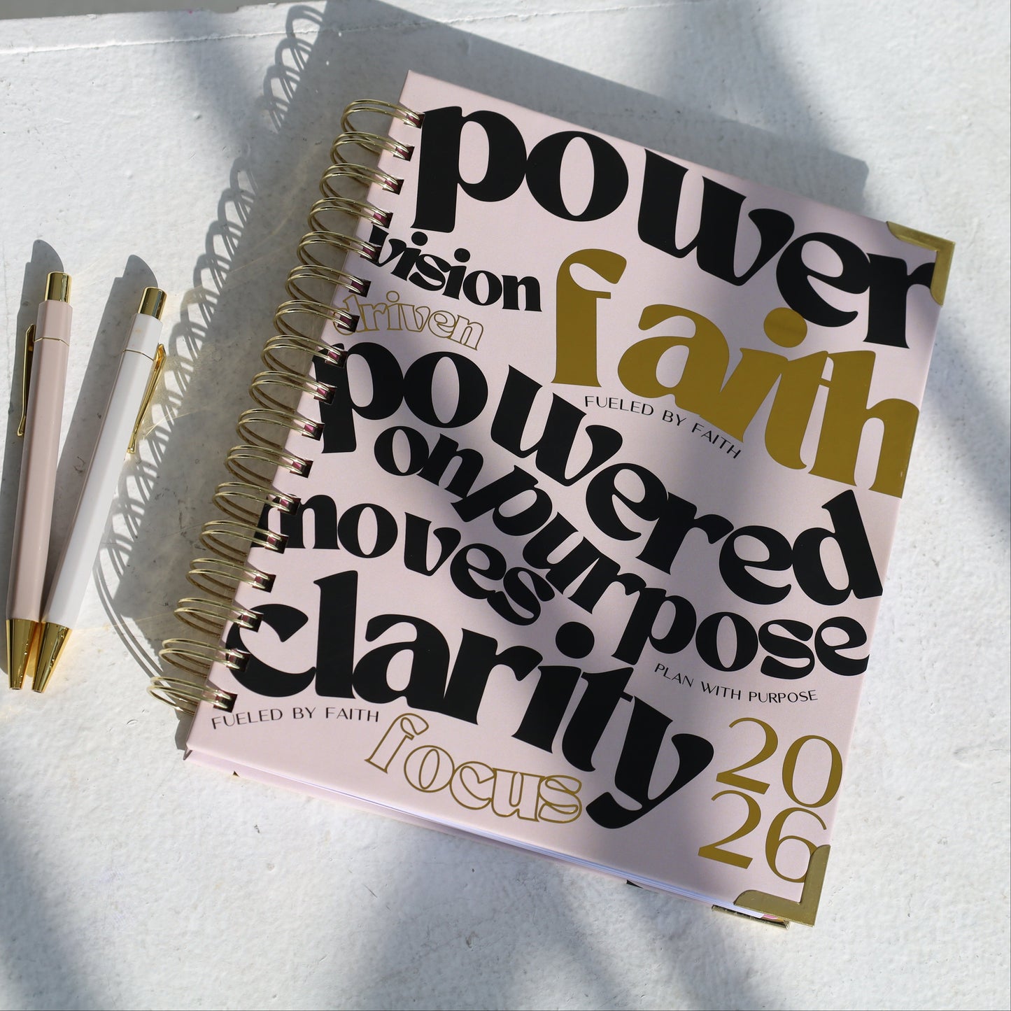 Notebook with motivational text on a light surface